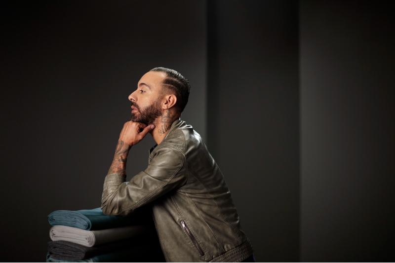 Rogério Lemos, conferente de tecidos, posa à frente de fundo preto